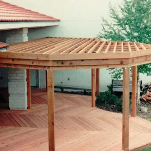 a pergolated deck with a pergolated roof