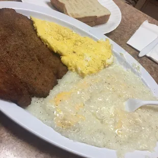 Cheese grits, fried tilapia, eggs and toast $9. Somebody smack me.