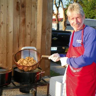 Dennis working hard at a fish fry!