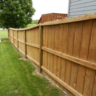 a wooden fence in a backyard