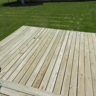a wooden deck in a backyard