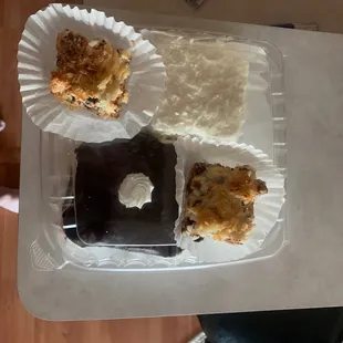 Two 7 layer bars/ magic bars, a chocolate cake and a coconut cake.