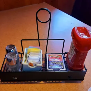 Assortments of sugar packets, salt &amp; pepper, jelly packets and a ketchup bottle were already situated at every table.