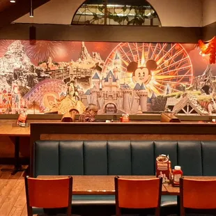 a view of a dining area with tables and chairs