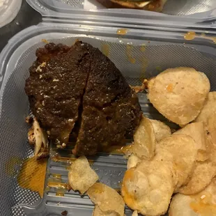 a hamburger and potato chips