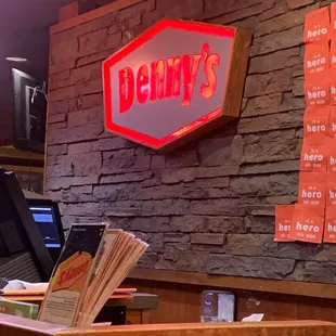 a brick wall with a neon sign