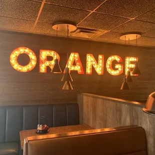 a neon sign that says orange