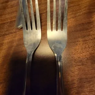 two forks on a wooden table