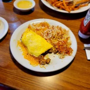 Omelet, hashbrowns, sampler in the background.