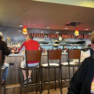 a woman sitting at a table in a restaurant