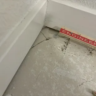 Broken subfloor cracked in a bunch of pieces hidden under the carpet, allowing poisonous fumes in