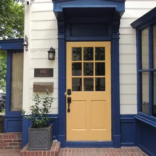 a yellow door and blue trim