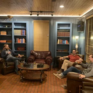 a group of men sitting in a living room