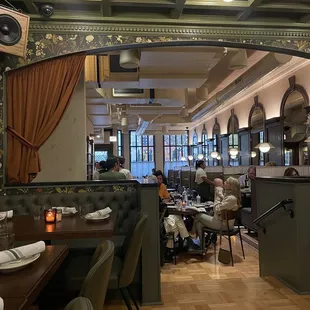 people sitting at tables in a restaurant