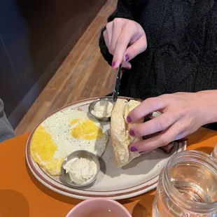 a person cutting a piece of bread