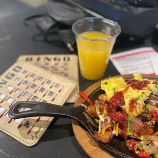a plate of food and a glass of orange juice