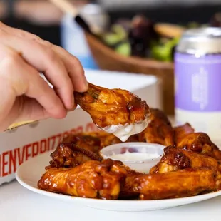 a plate of wings with dipping sauce