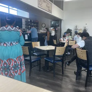 people sitting at tables in a restaurant