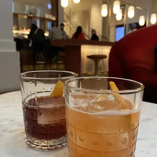 two glasses of cocktail on a table