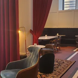 the interior of a restaurant with tables and chairs