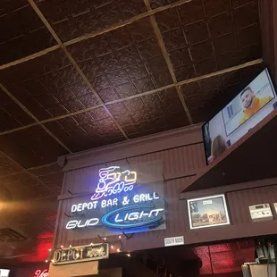 a neon sign above the bar