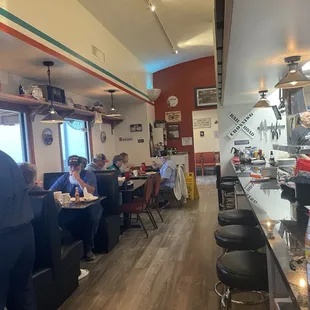 customers sitting at tables in a restaurant