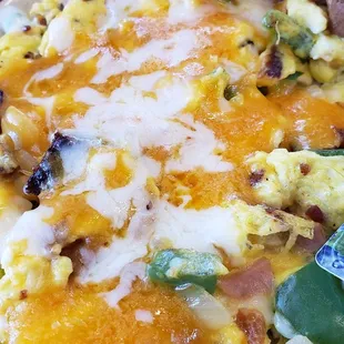 Scrambler filled with veggies. side of toast and a hashbrown patty.