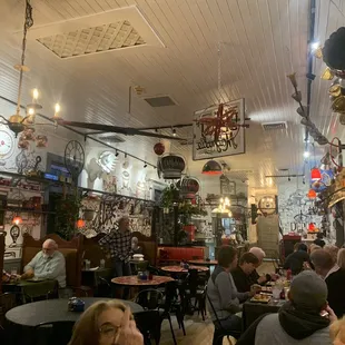 people sitting at tables in a restaurant