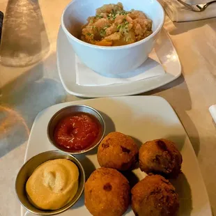 a plate of food and a bowl of sauce