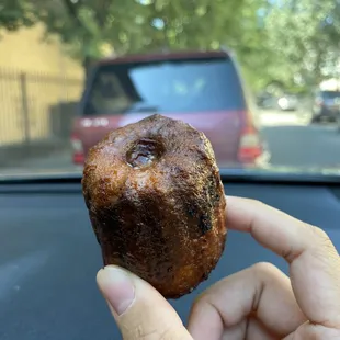 a person holding a donut in their hand