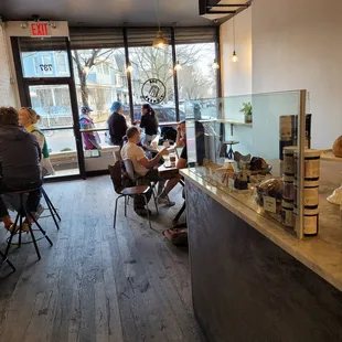 people sitting at tables in a coffee shop