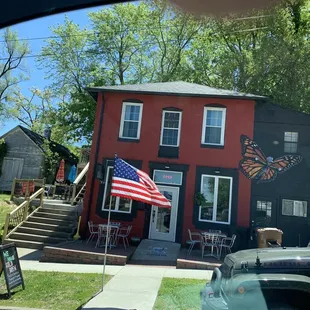 a red house with a butterfly painted on it