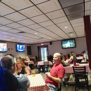 people sitting at tables in a restaurant