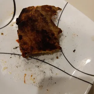 a half eaten piece of pizza