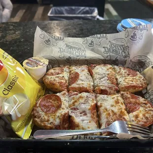 a tray of pizza and chips