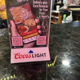 a hand holding a box of pizza