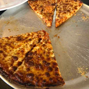 four slices of pizza on a pizza pan