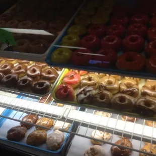 a variety of donuts in a display case