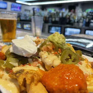 a plate of nachos and a glass of beer