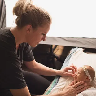 Cori, behind the scenes, with an itty bitty baby.