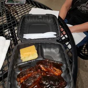 ribs and cheese in a plastic container