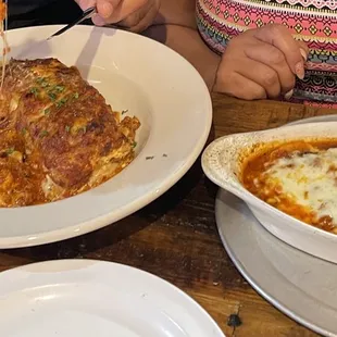 a woman cutting into her dish