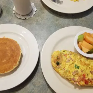 Two pancakes, Western omelette, and fruit.