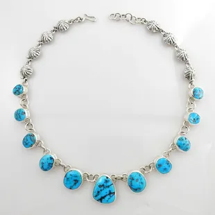 This is a beautiful sterling silver adjustable necklace featuring kingman blue turquoise