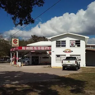 a gas station with a truck parked in front of it