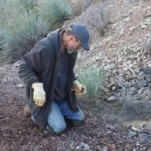 Mike looking thru the tailings piles to find some beautiful rocks with crystals growing on and in them.   Part of the ATV tour.