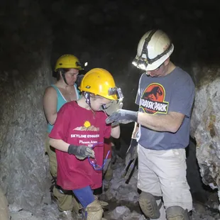 Ron and Hannah looking at a specimen they hammered off one of the walls.  Hanna 13, looks thru 10X jewelers loupe.