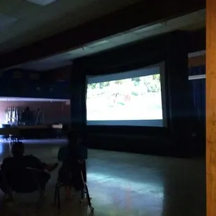 The huge screen touched the cafeteria ceiling!