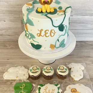 a decorated cake and cupcakes
