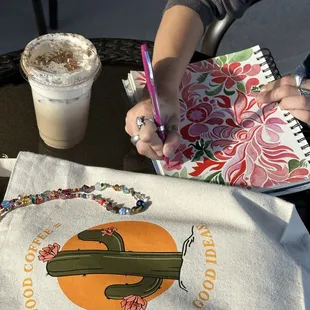 a person writing on a notebook